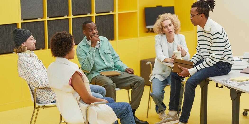 Five workers are having a discussion