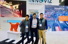 Shinya Shinoda, Omer Keilaf, and Jizheng Luan standing in front of Innoviz Technologies display