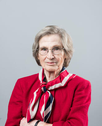 Image of MIT Sloan Professor Emerita Lotte Bailyn in a red jacket