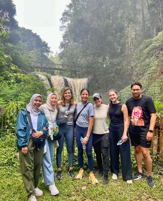 Photo of G-Lab team in front of a waterfall