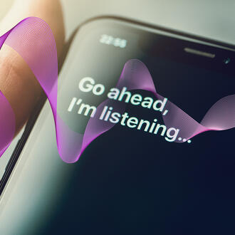 An iphone with Siri's words "Go ahead, I'm listening" on the screen. Graphic AI sound waves move through it. 