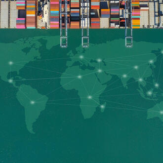 A cargo ship in the ocean. A world map is transposed in the water.