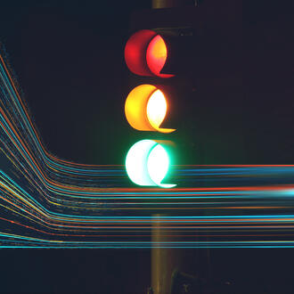 A traffic light with abstract data lines running through it