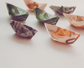 Origami boats made out of paper currency from various countries 