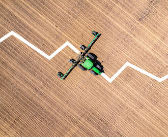A downward sloped graph is overlayed on top of a John Deere tractor photograph