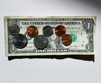 Coins on top of a dollar bill
