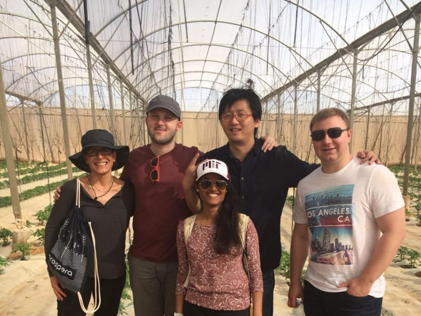 Prospera team standing inside a greenhouse 