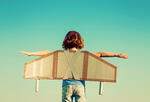Child flies homemade cardboard plane