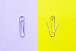 One paperclip is intact and another paperclip is open.