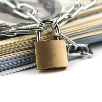 A heap of money  chained up with a locak