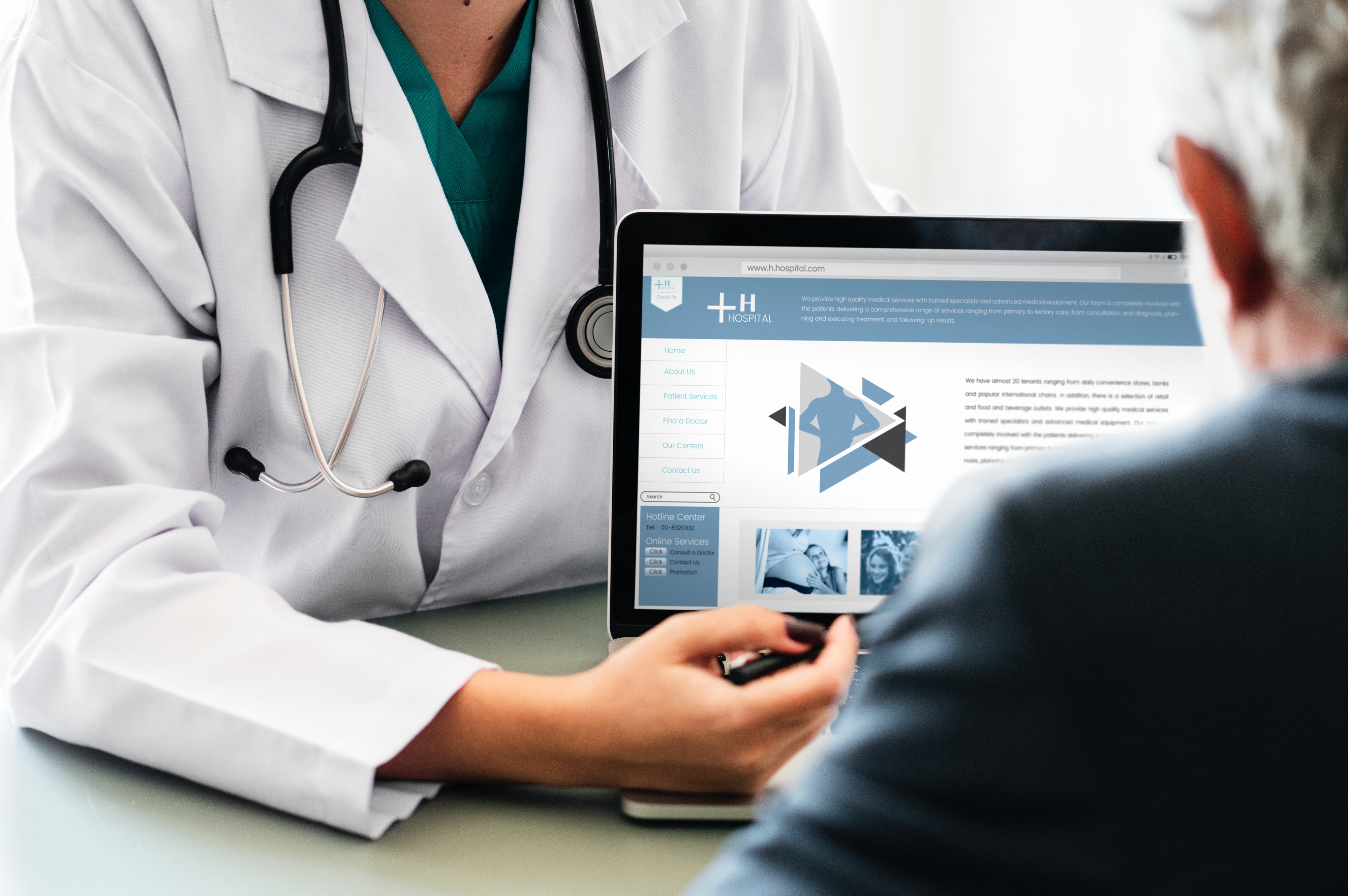 Doctor showing person a laptop screen