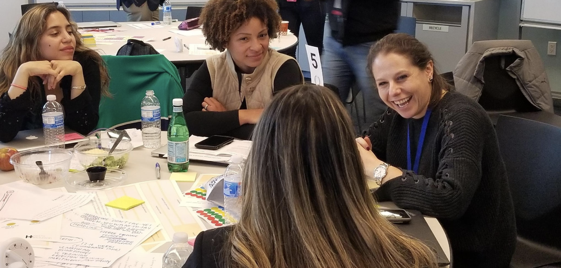 Women around a table at the MIT Sloan Hack for Inclusion