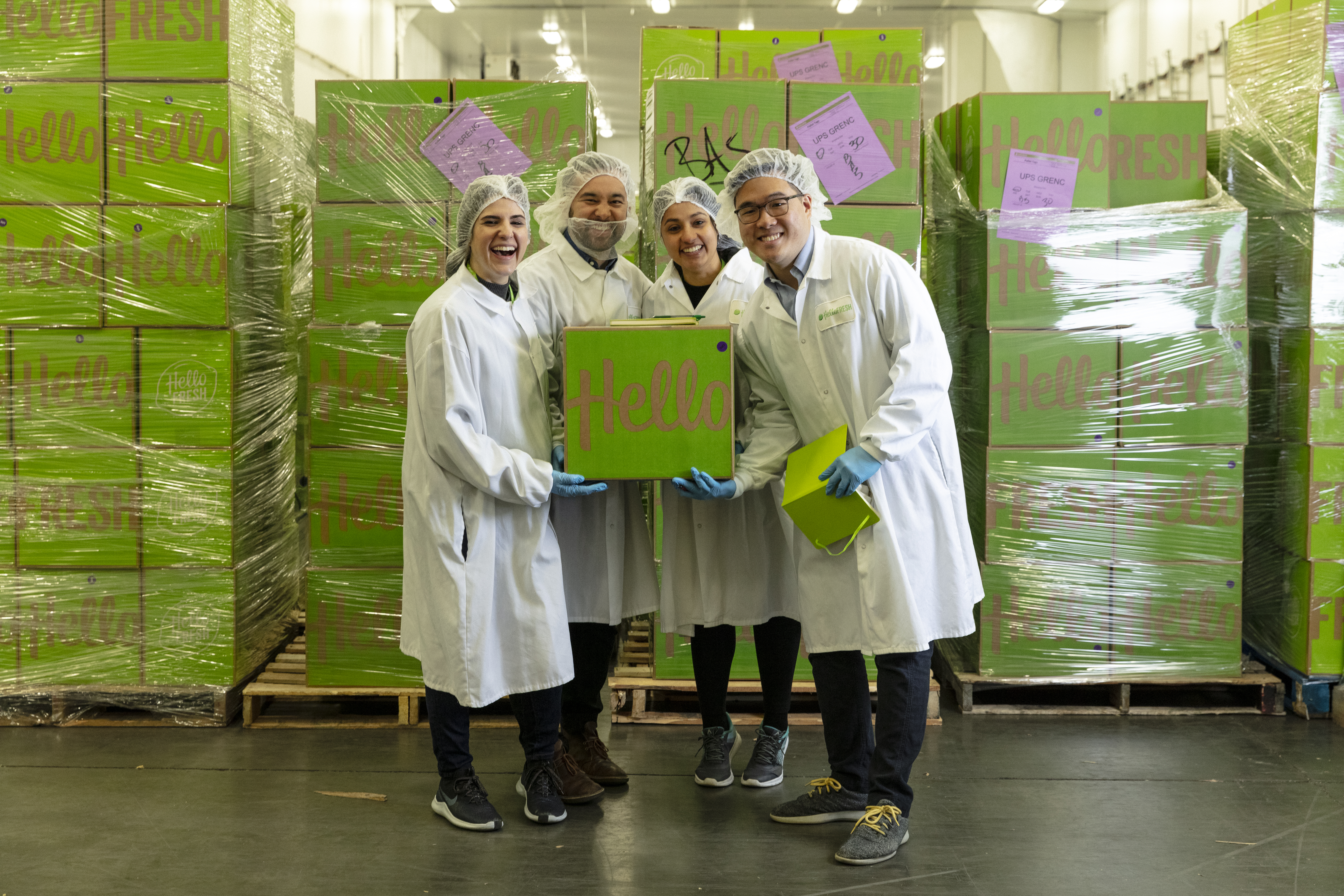 Ops-Lab team holding HelloFresh box with host