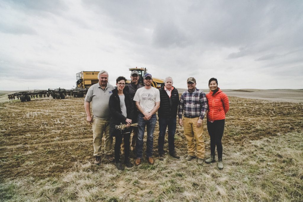 S-Lab students standing in field with hosts.