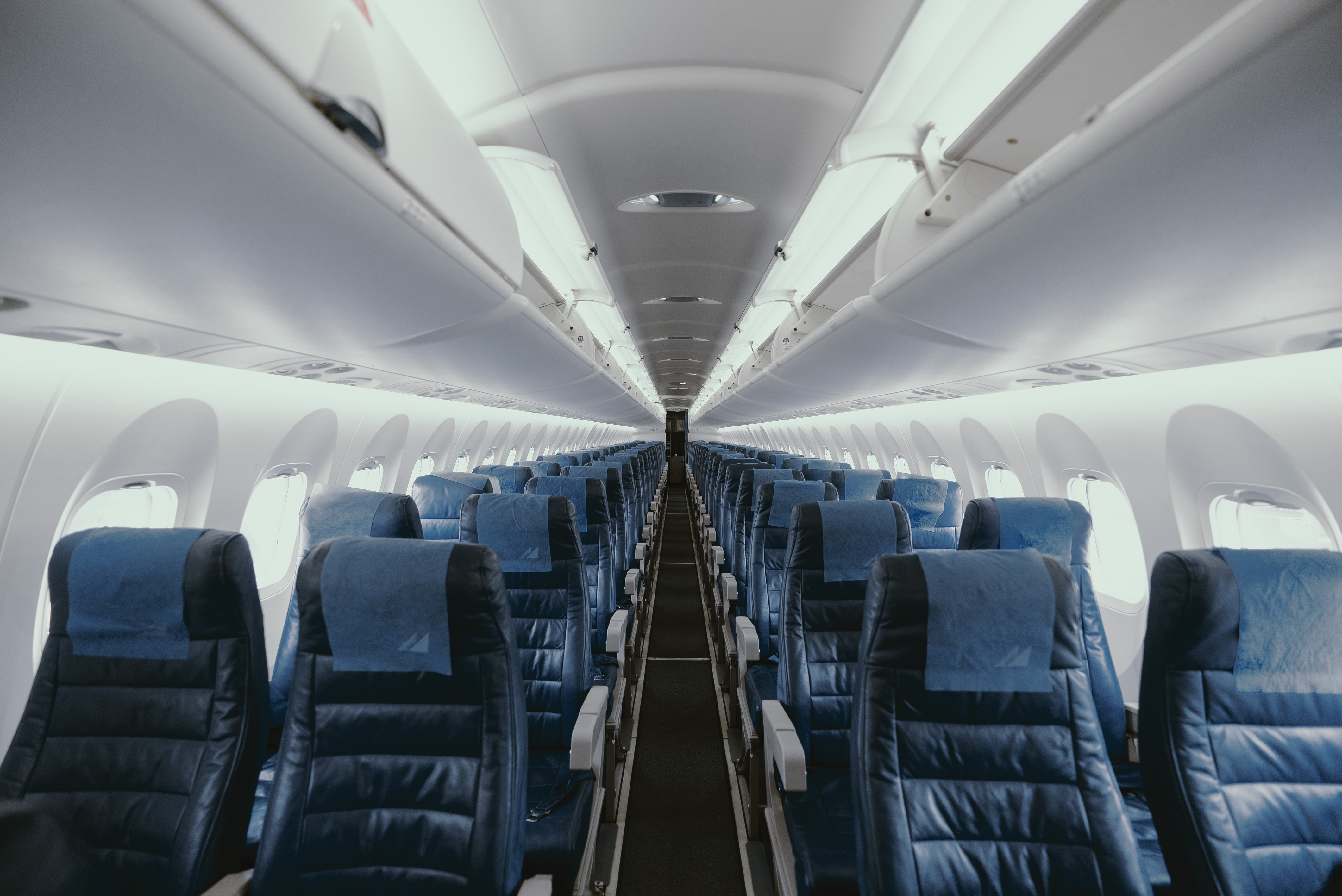Blue empty seats in airplane interior.