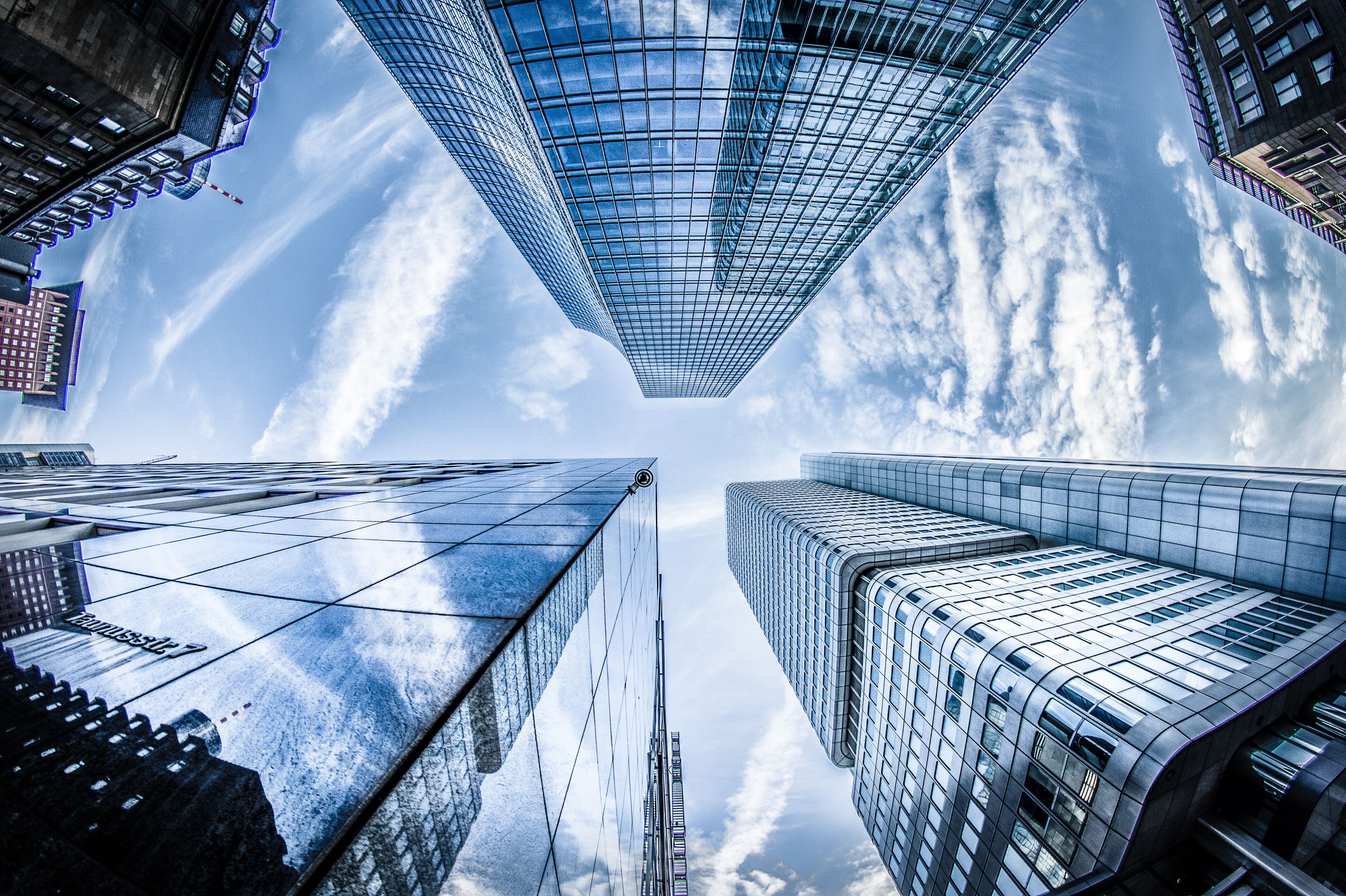 Low angle photo of four high rise buildings