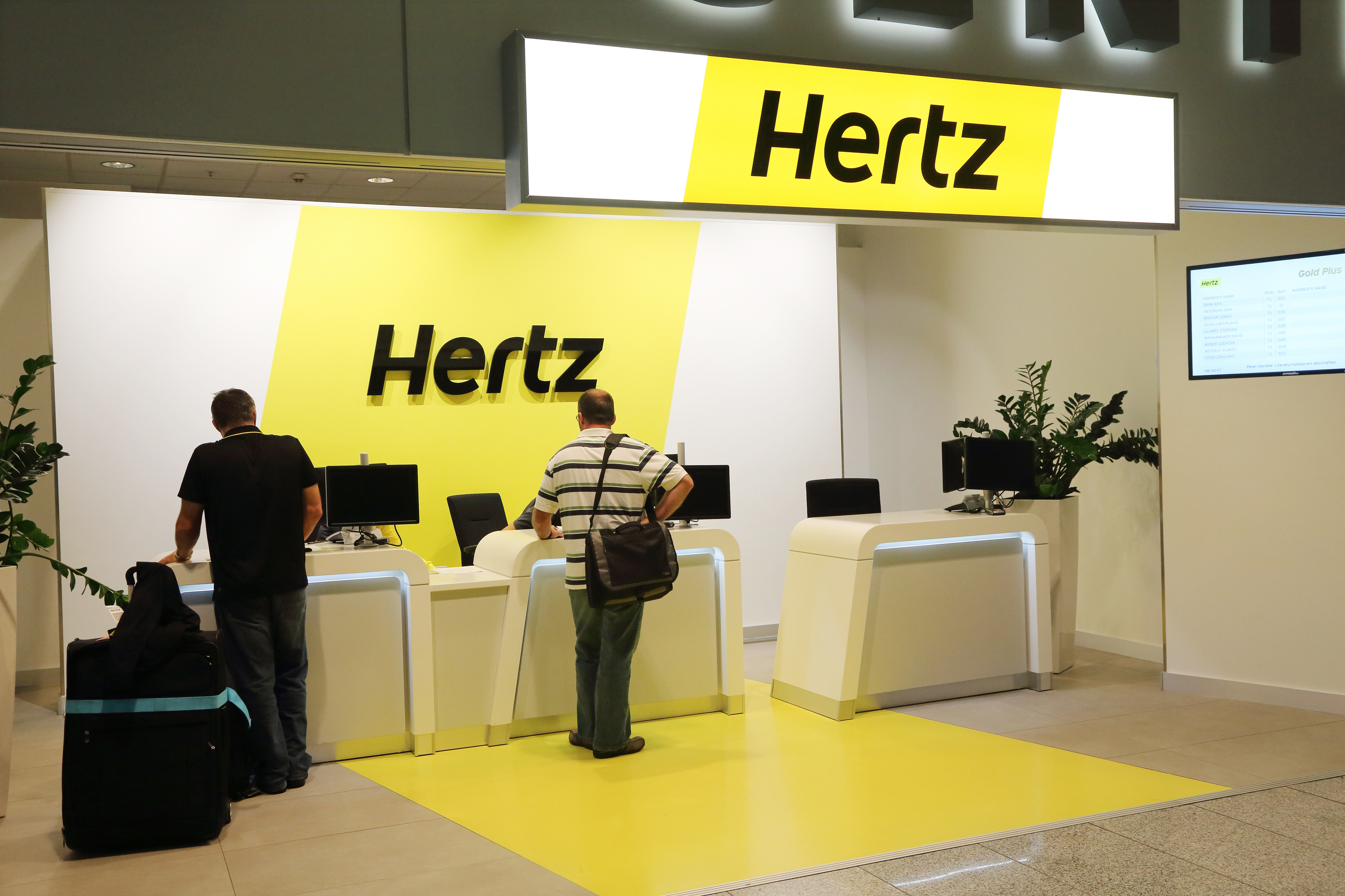 Hertz Car Rental customer kiosk with people