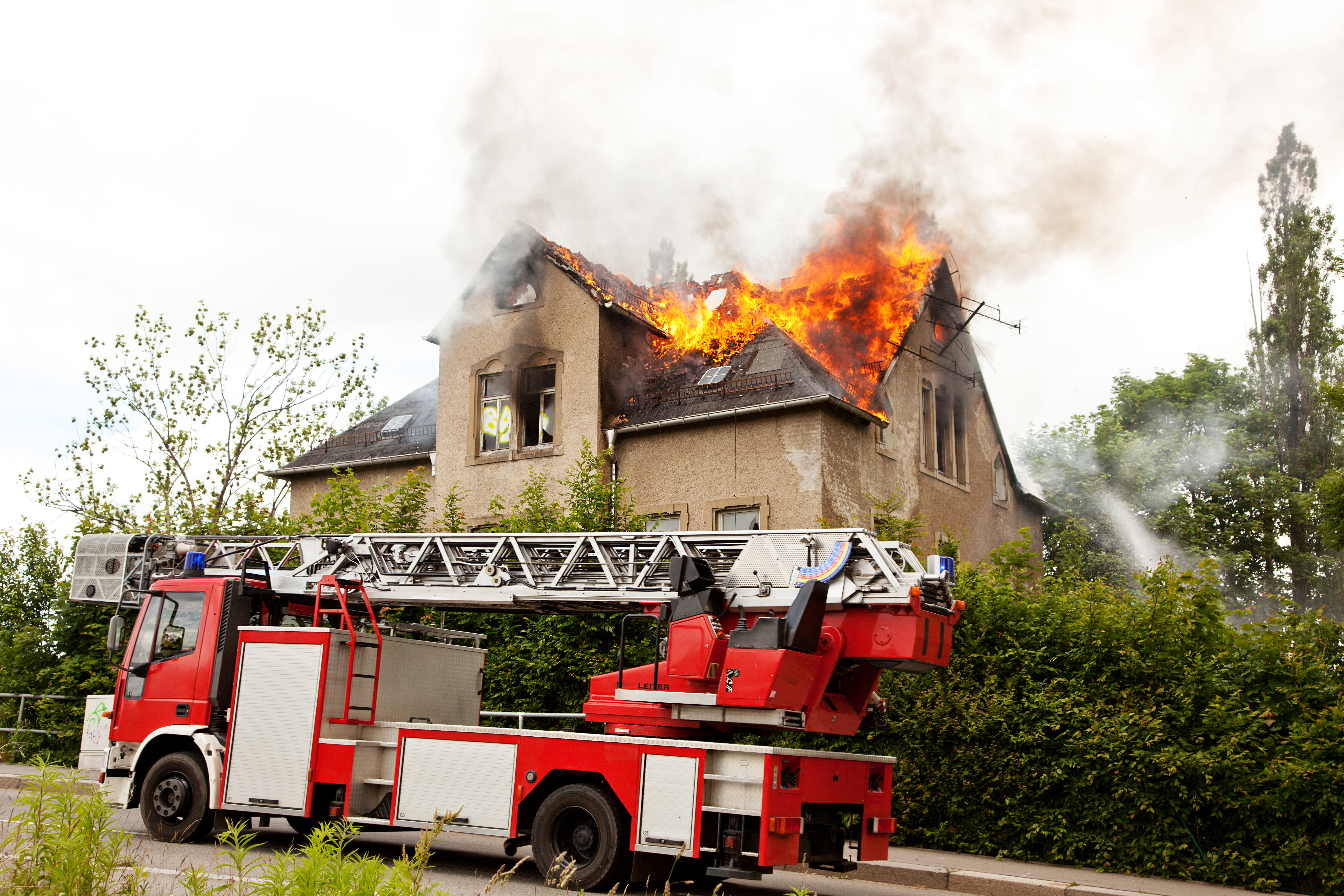 House burning with fire truck in front