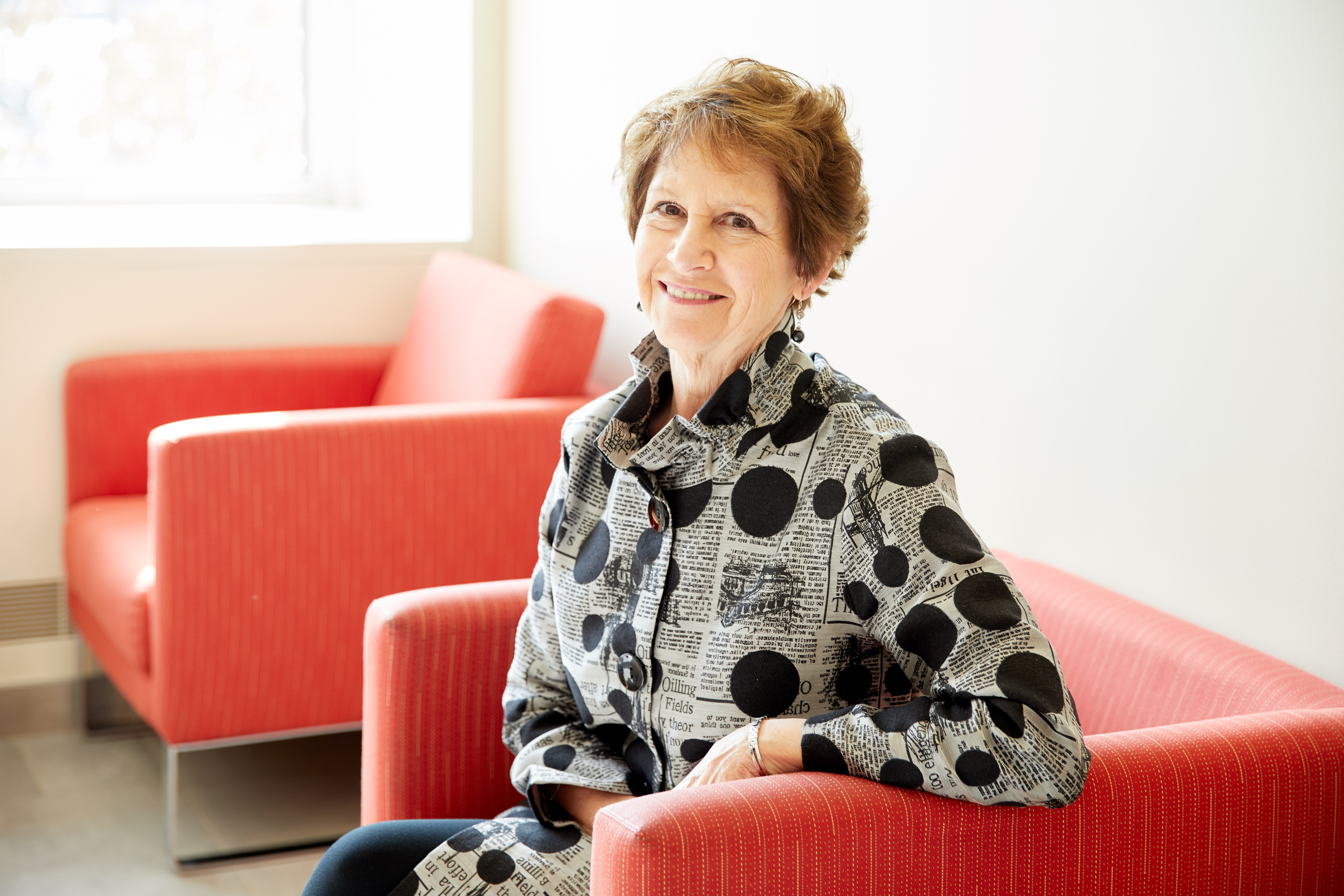 Nancy Van Milligen, CEO and president of the Community Foundation of Greater Dubuque, sitting in red chair