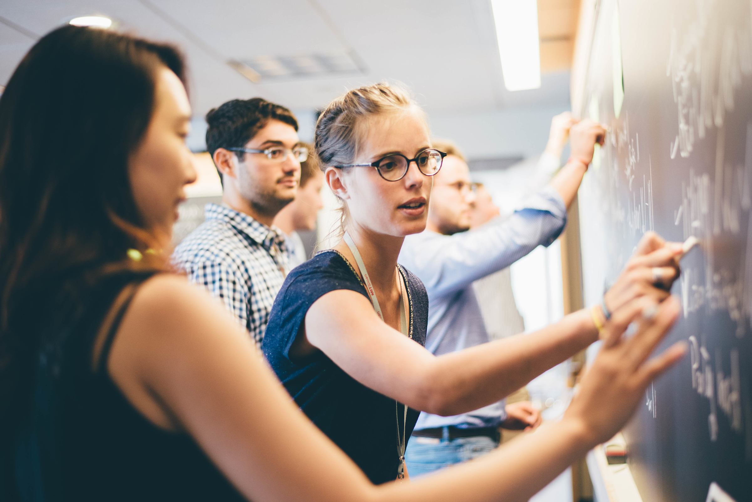 MIT Sloan Visiting Fellows at chalkboard