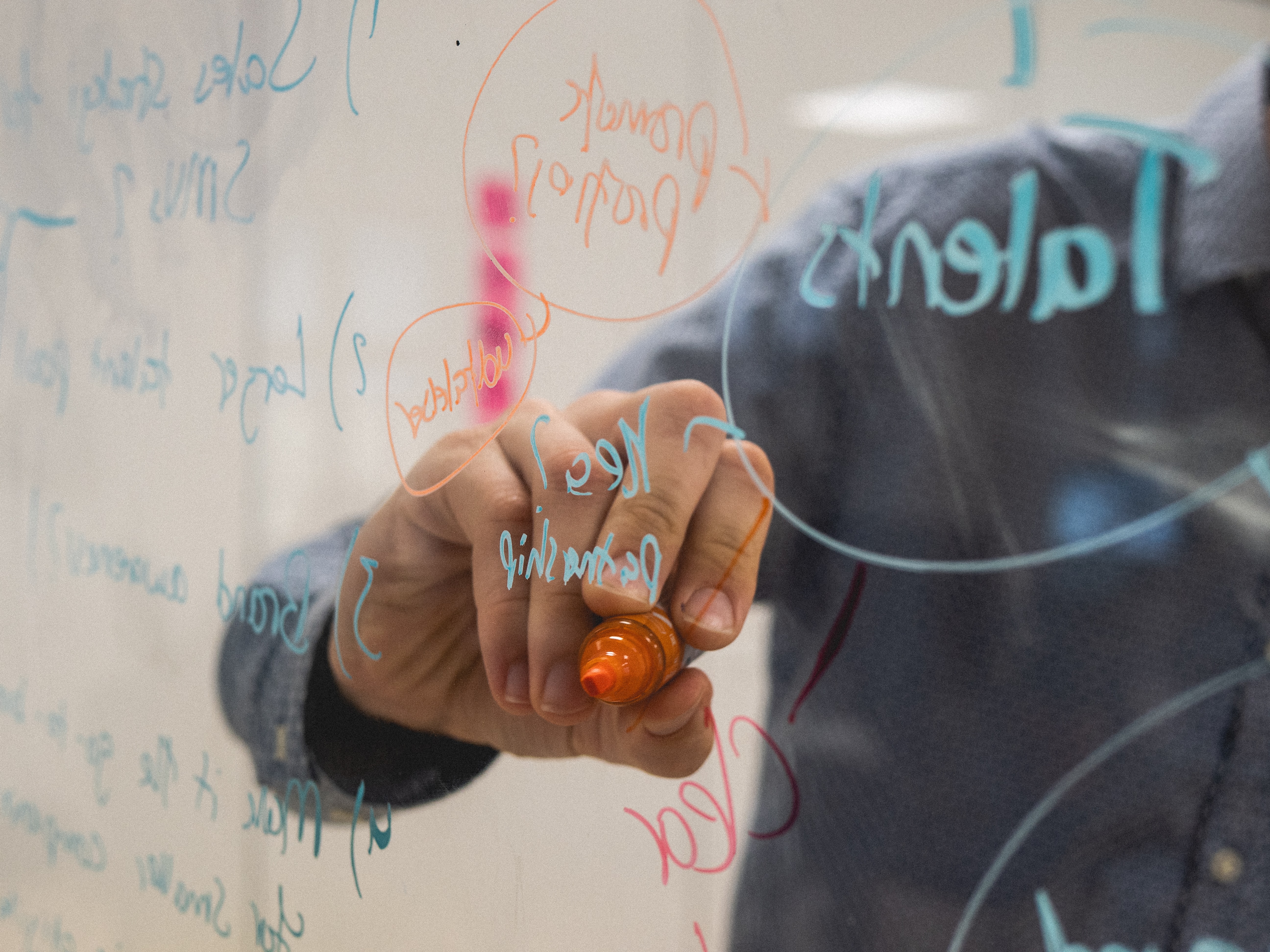Person writing on glass wall