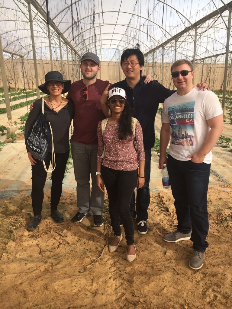 Prospera team standing inside a greenhouse