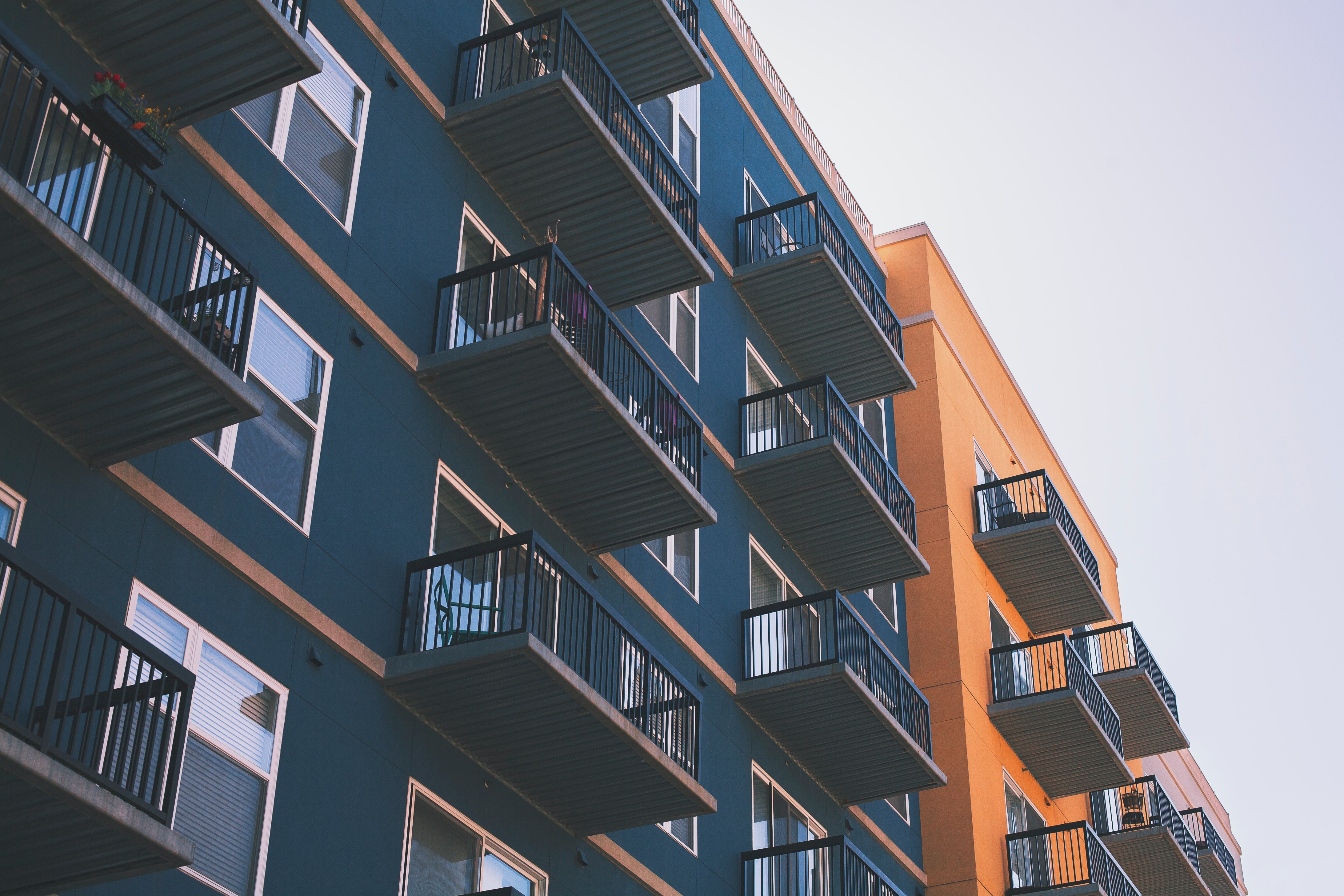 Dark green and orange apartment building with balconies