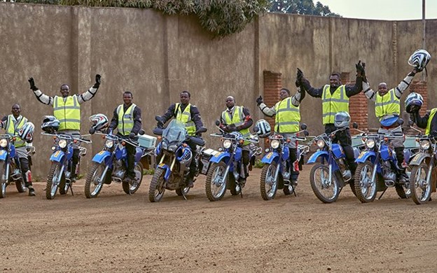 Nine Riders for Health cheering on their motorcycles in Malawi