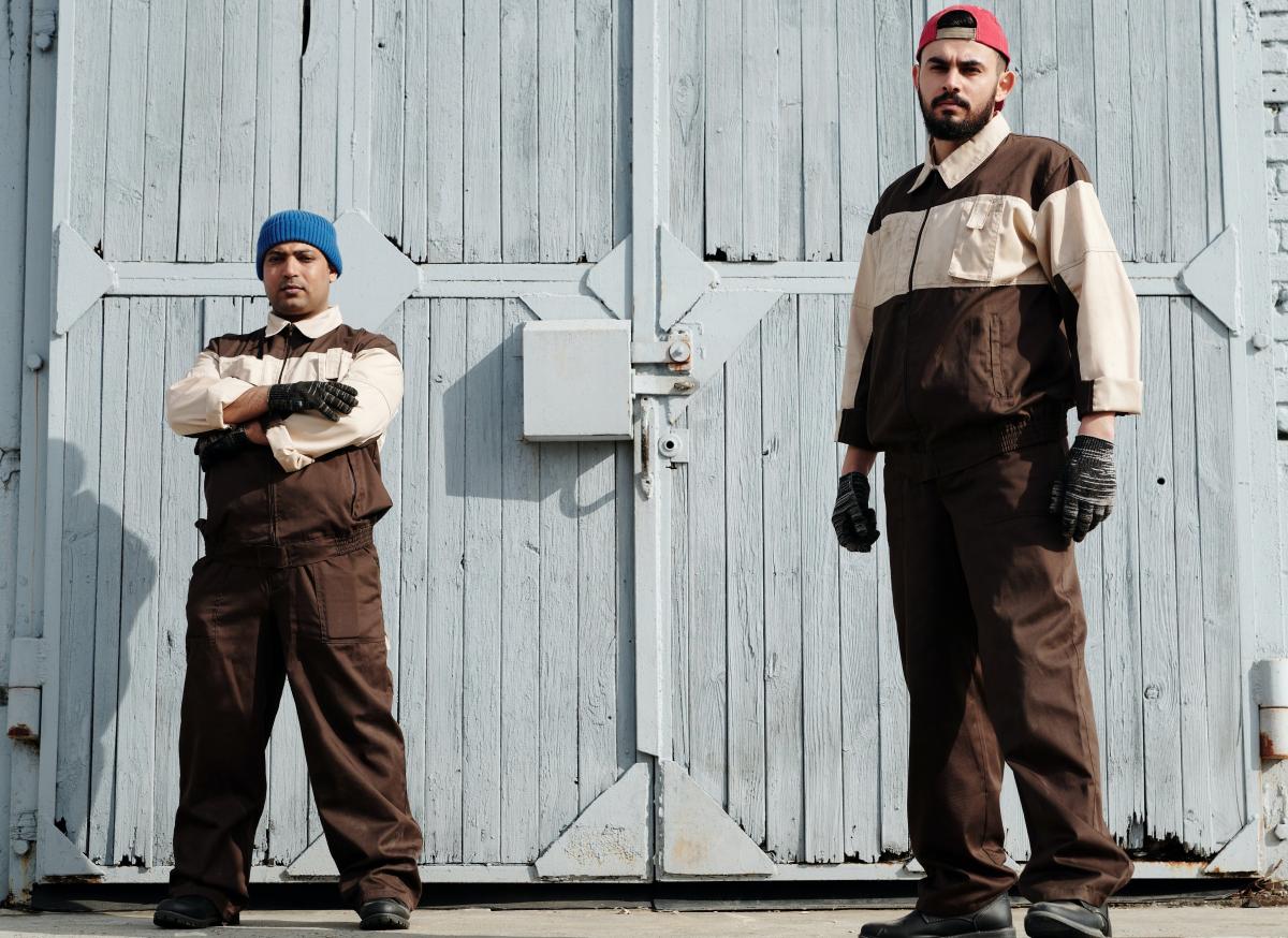 Two men in front of a warehouse