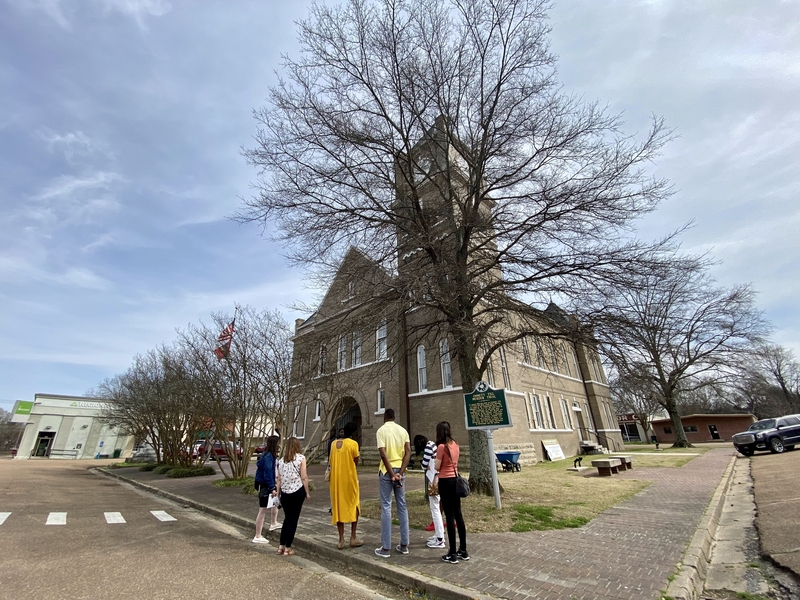 Caption:Students reflect in front of the courthouse where the Emmett Till murder trial took place in Sumner, Mississippi.
