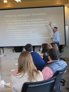 A photograph of a researcher presenting at one of the weekly IWER seminars at MIT Sloan.
