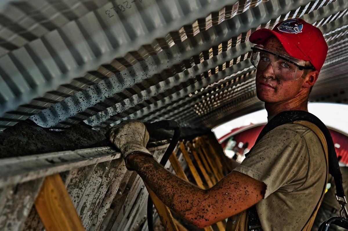 Construction worker holding a ladder