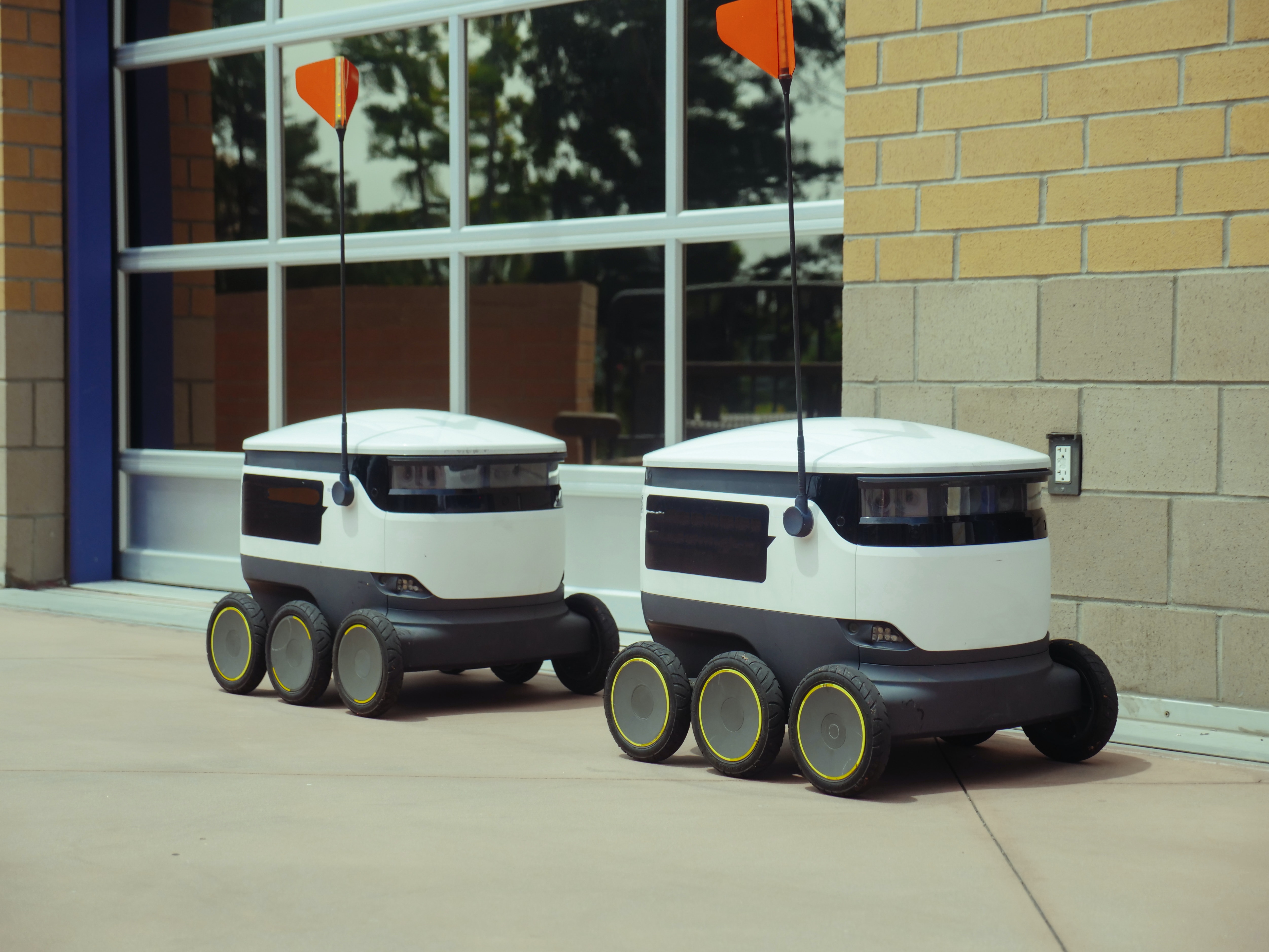 Delivery robots outside on the sidewalk