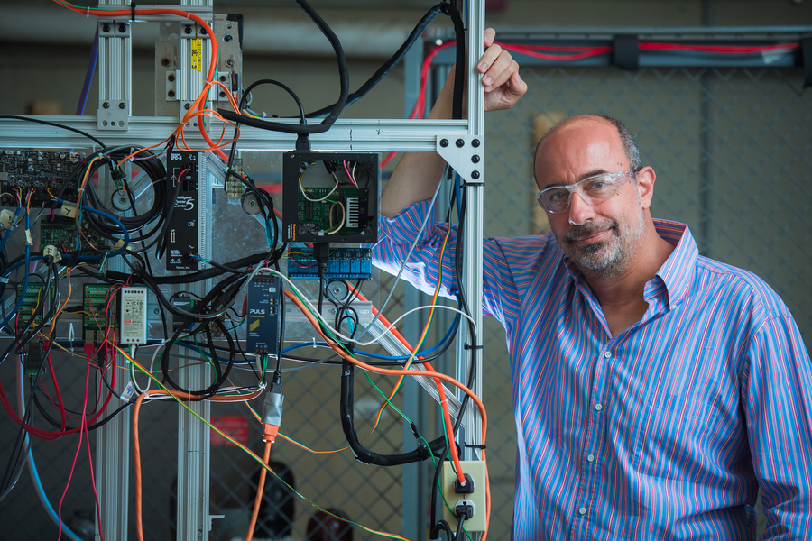 George Lordos poses with lab equipment.