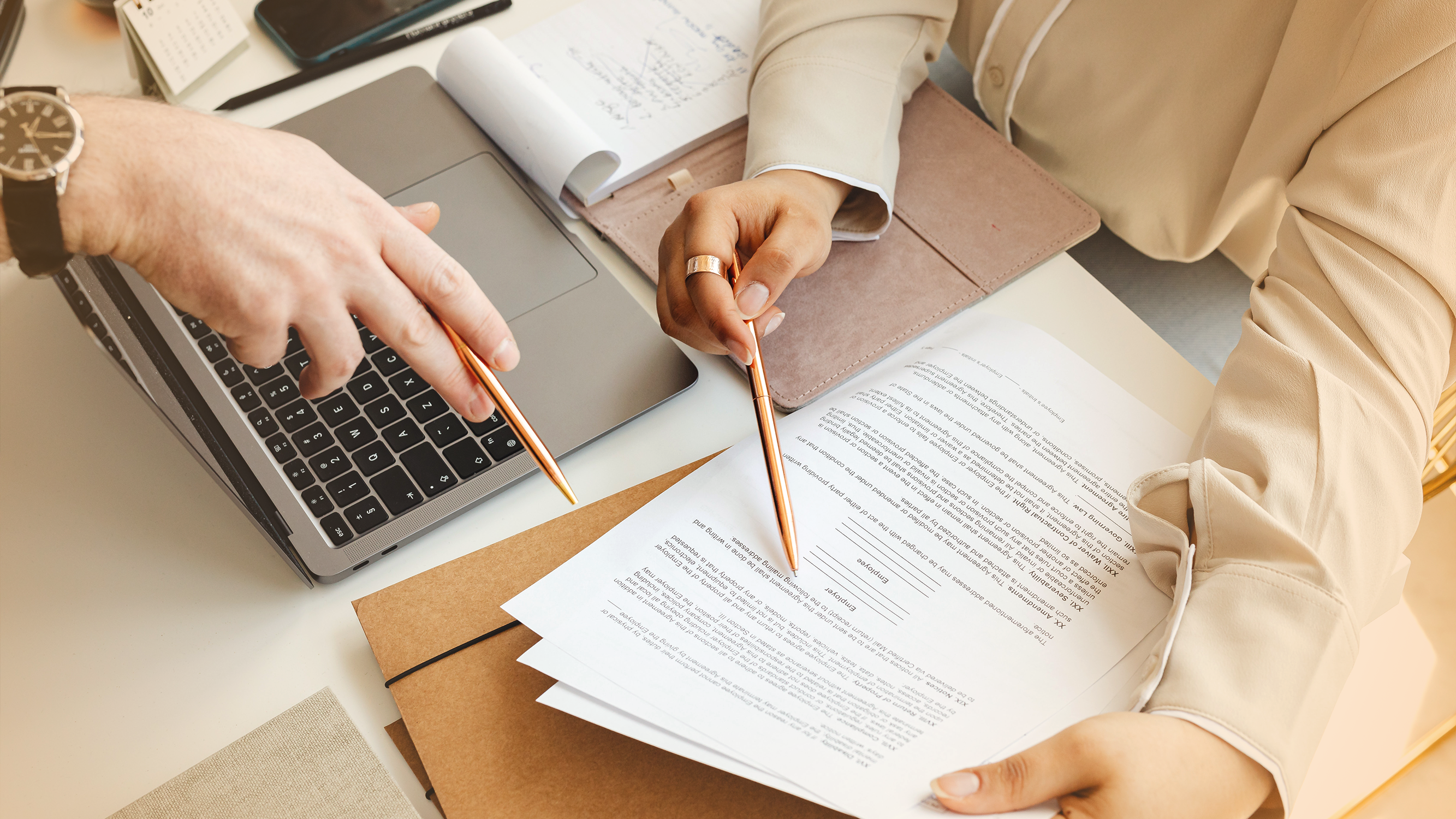 Two people reviewing paperwork on a table