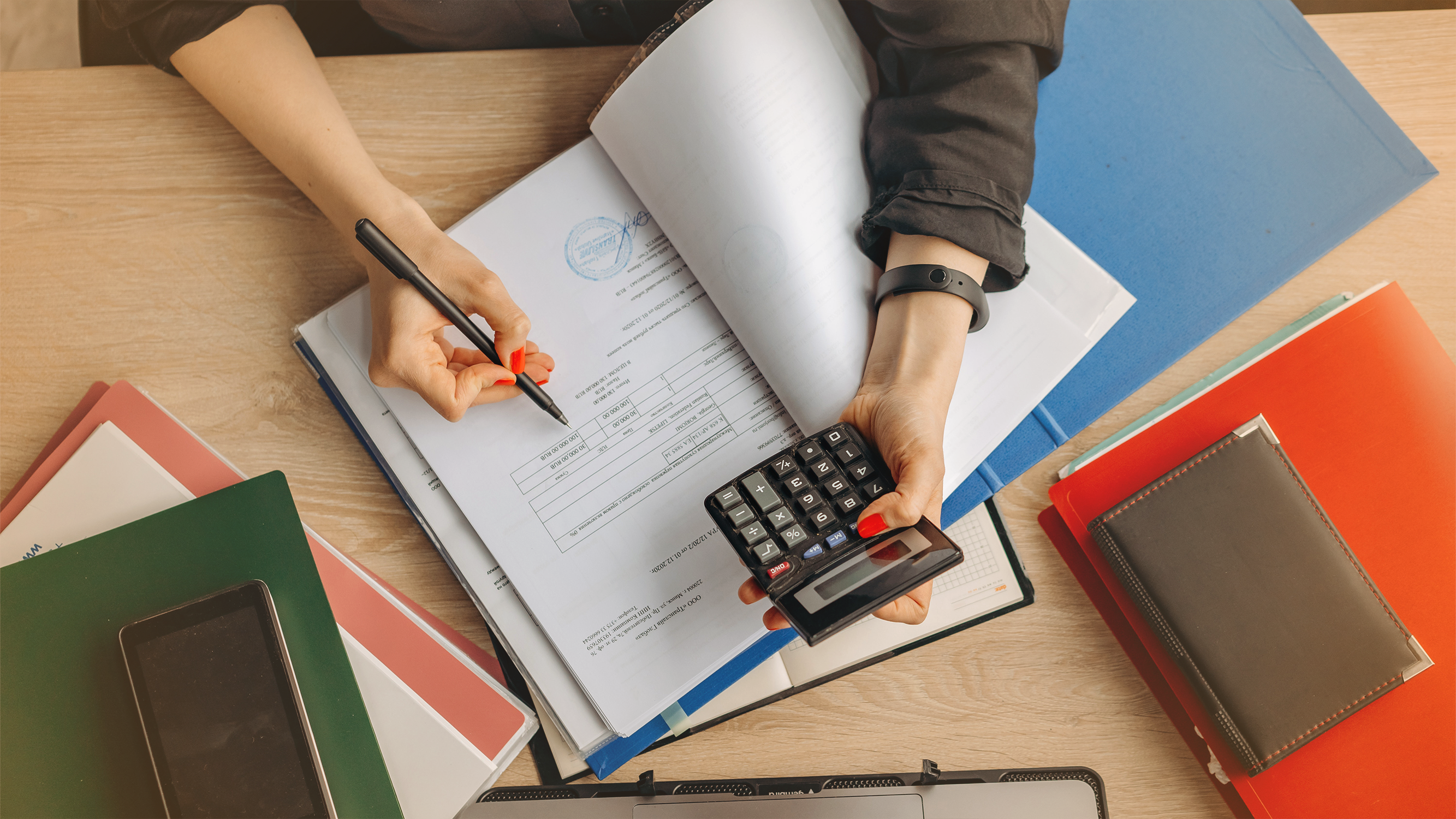 Person working on accounting paperwork