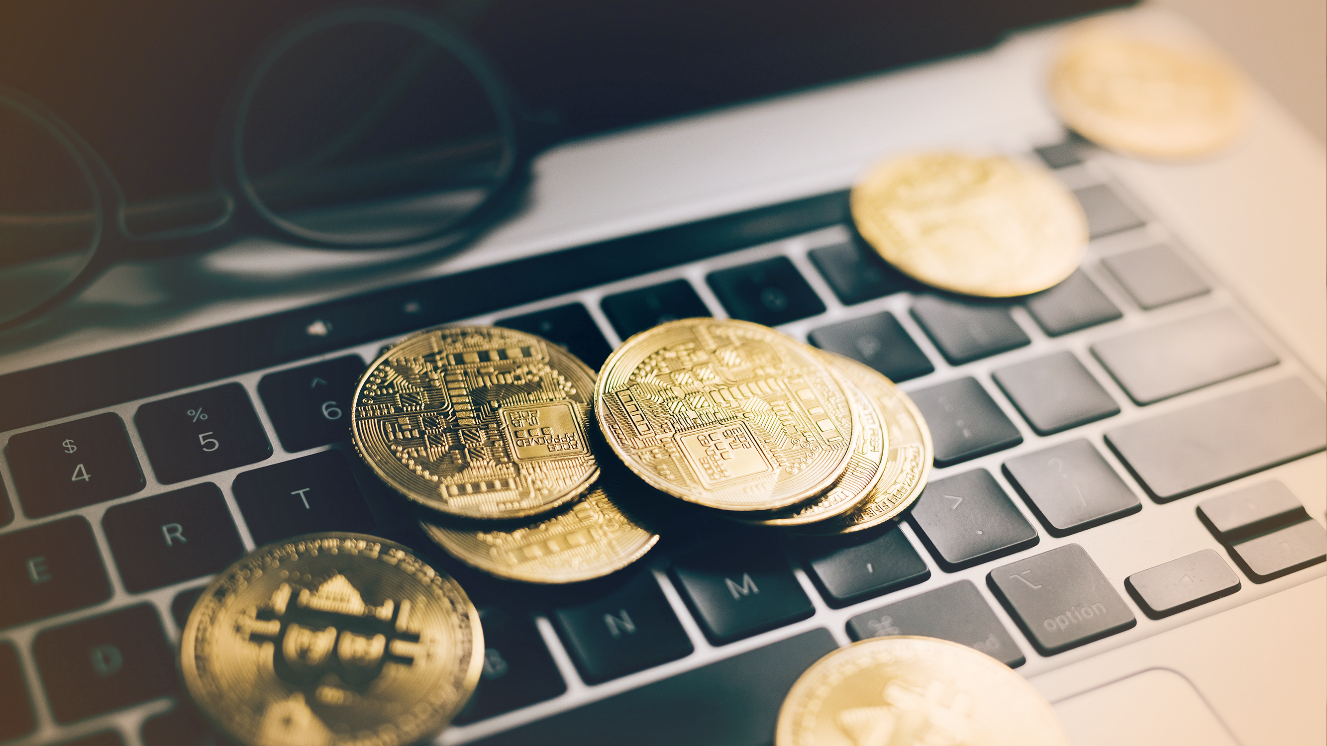 Cryptocurrency on keyboard, relating to blockchain and the bitcoin market