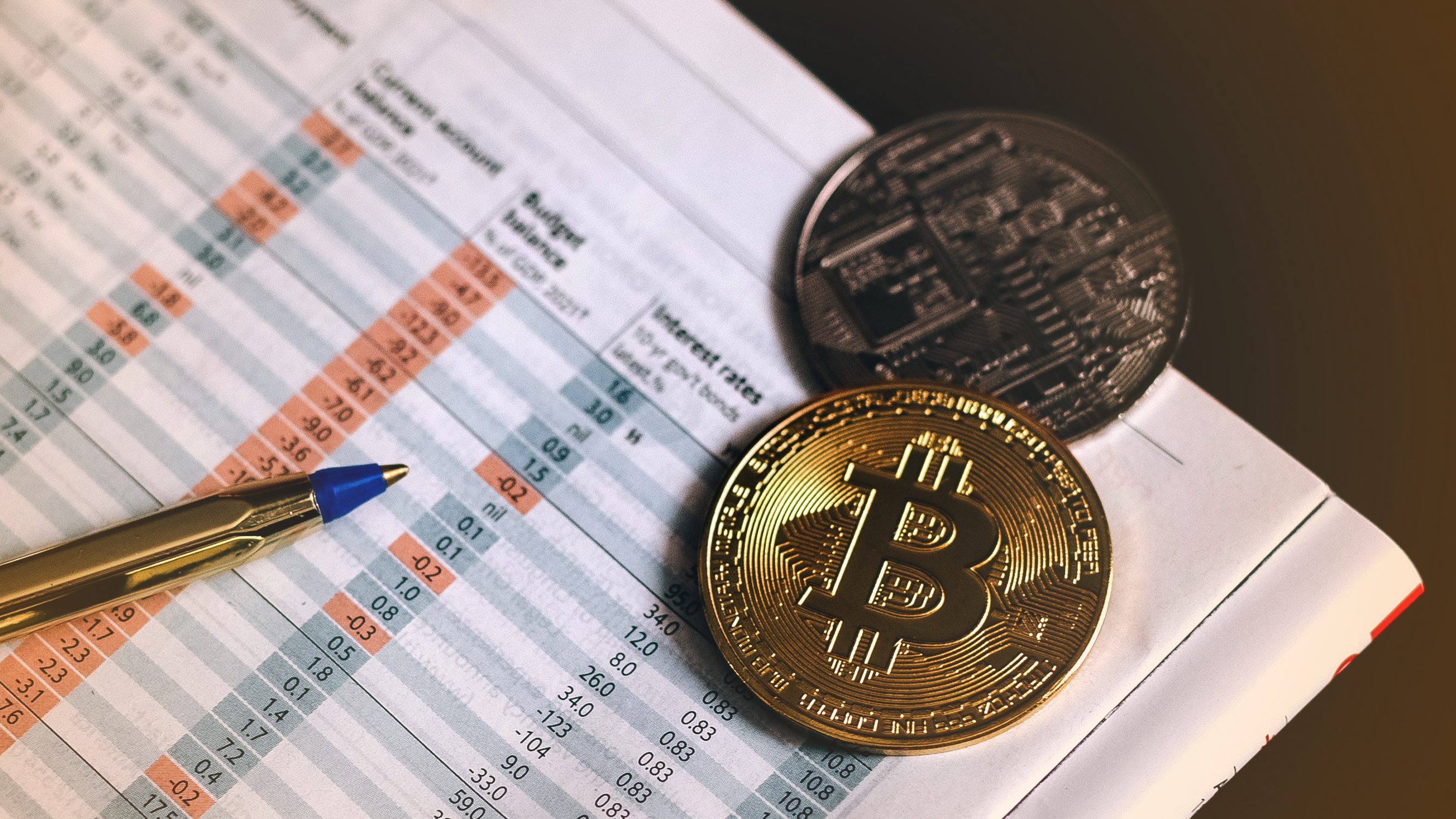 Cryptocurrency coins on interest rate sheet, bitcoins