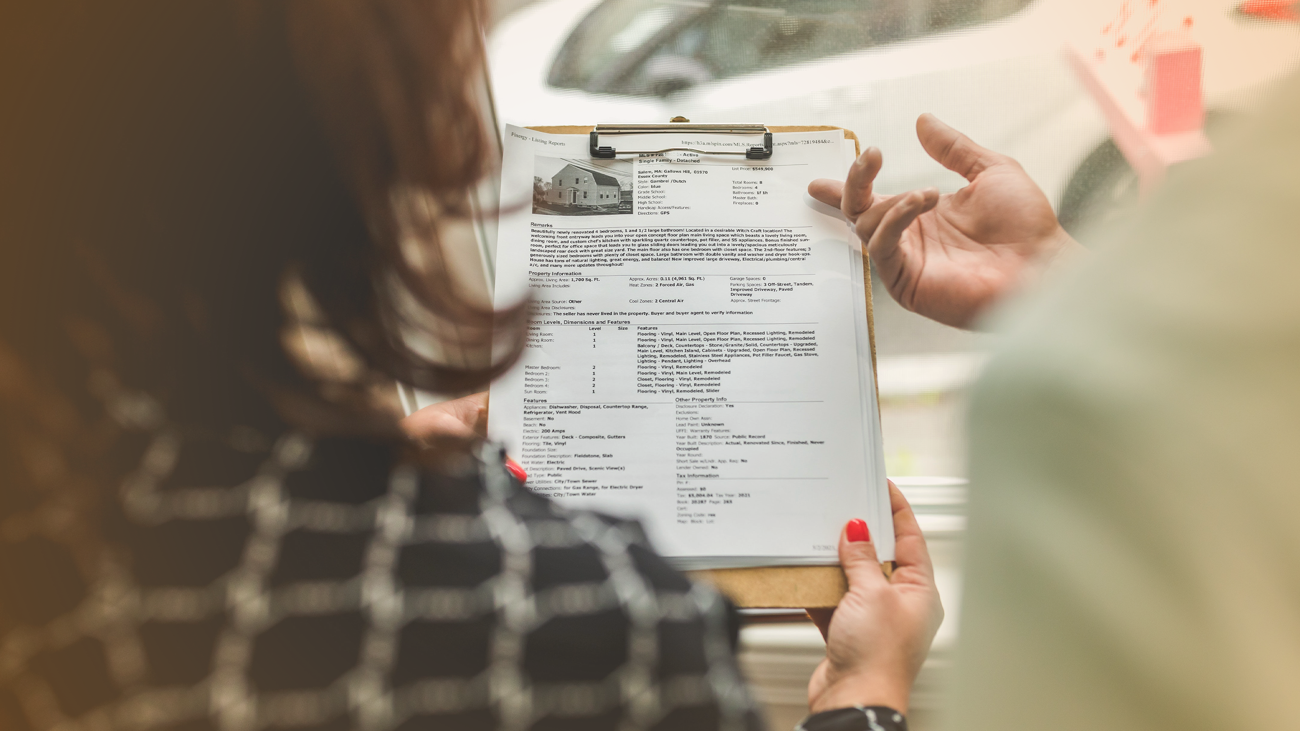 Woman looking at a home listing on paper