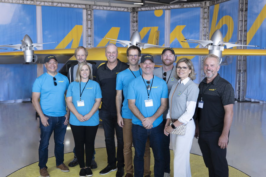 Caption:Leon Villegas (left) stands with the Wisk Aero executive team at the launch of their Generation 6 aircraft.