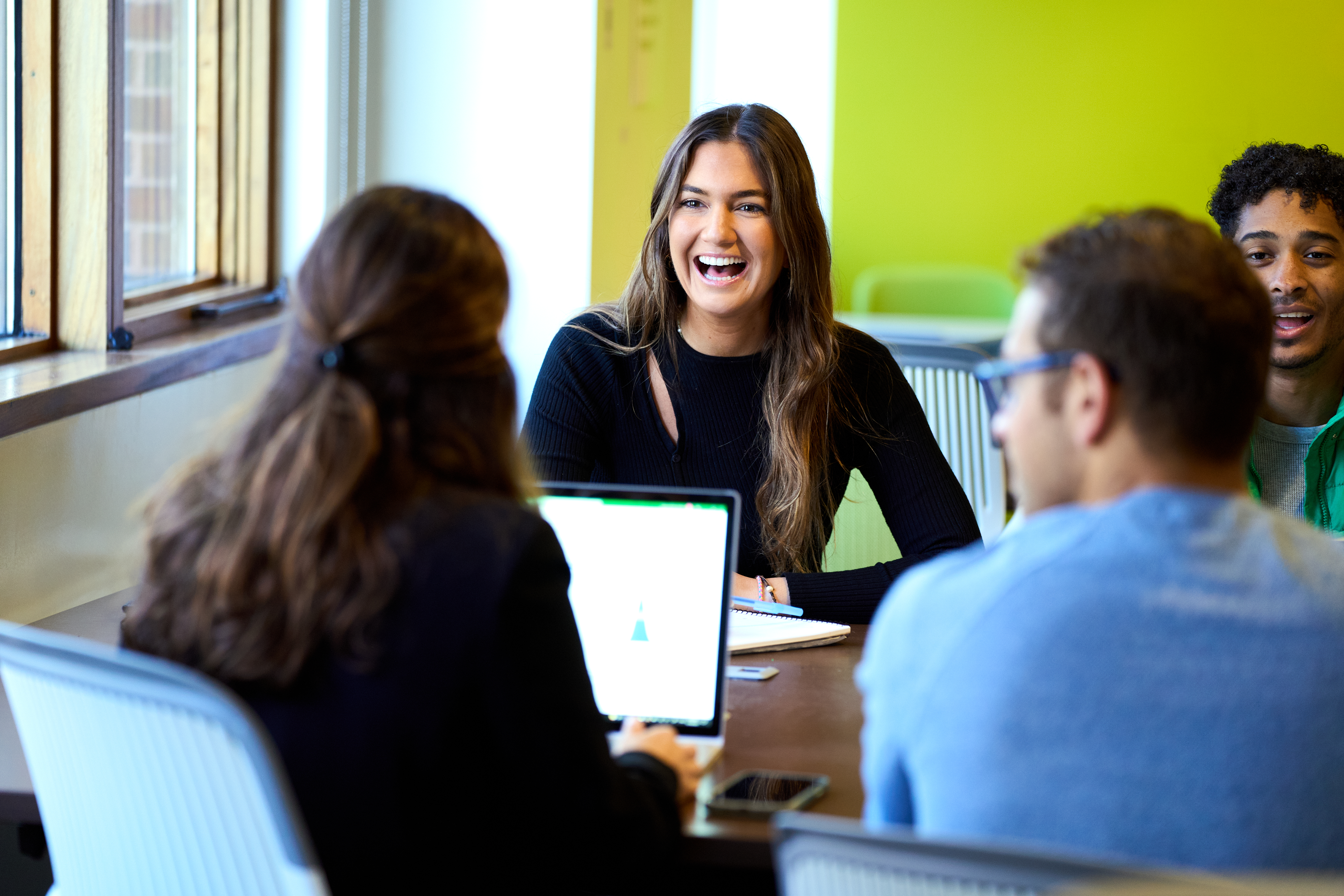 A group of four students talking