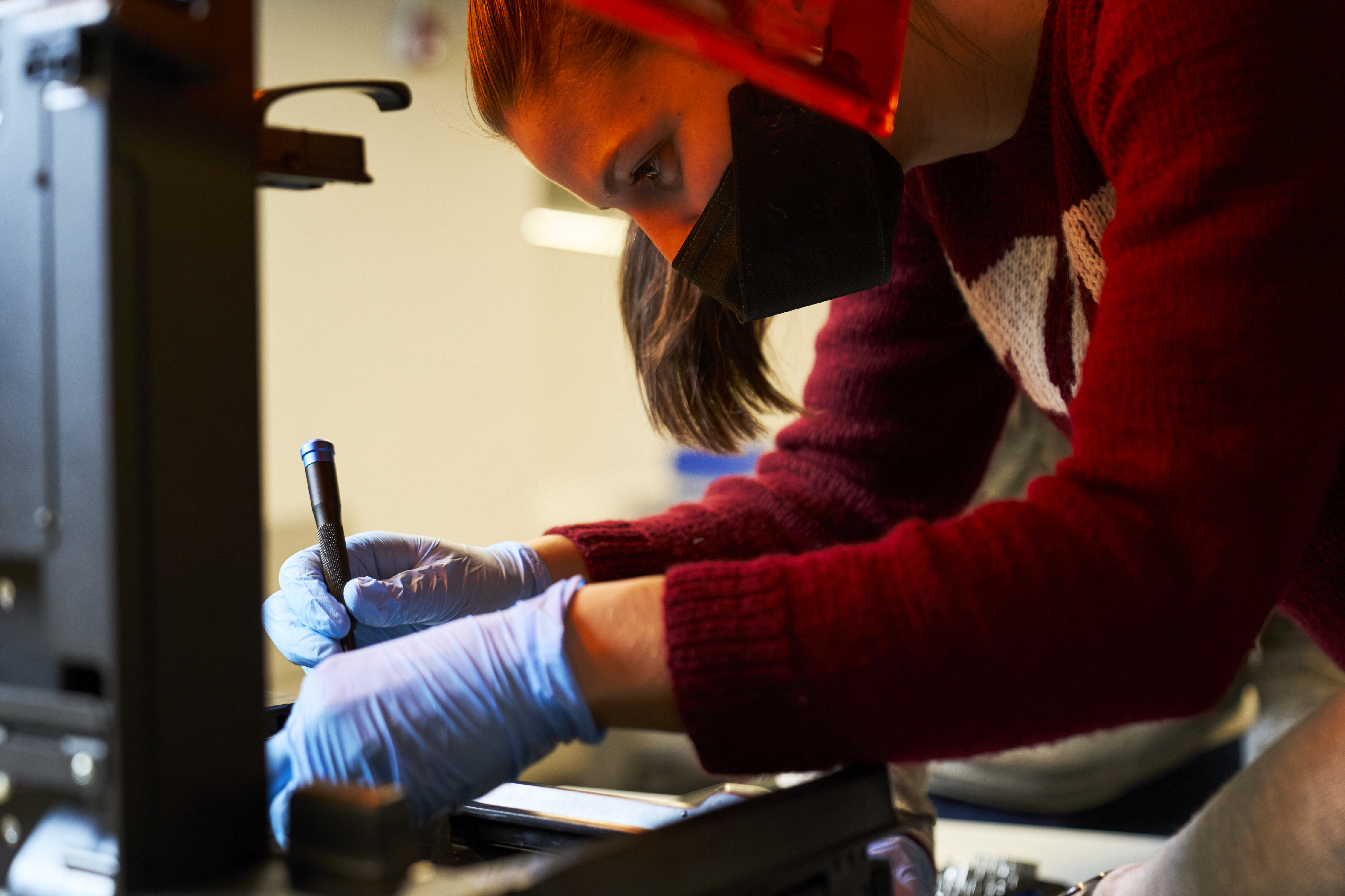 LGO student Lisa Schleuter taking apart 3D printer