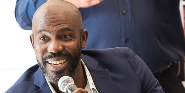 Daniel Auguste speaks to an audience on campus