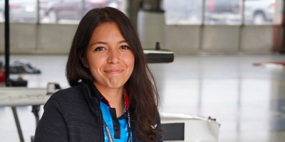 Cindy Heredia poses for a photo in a garage