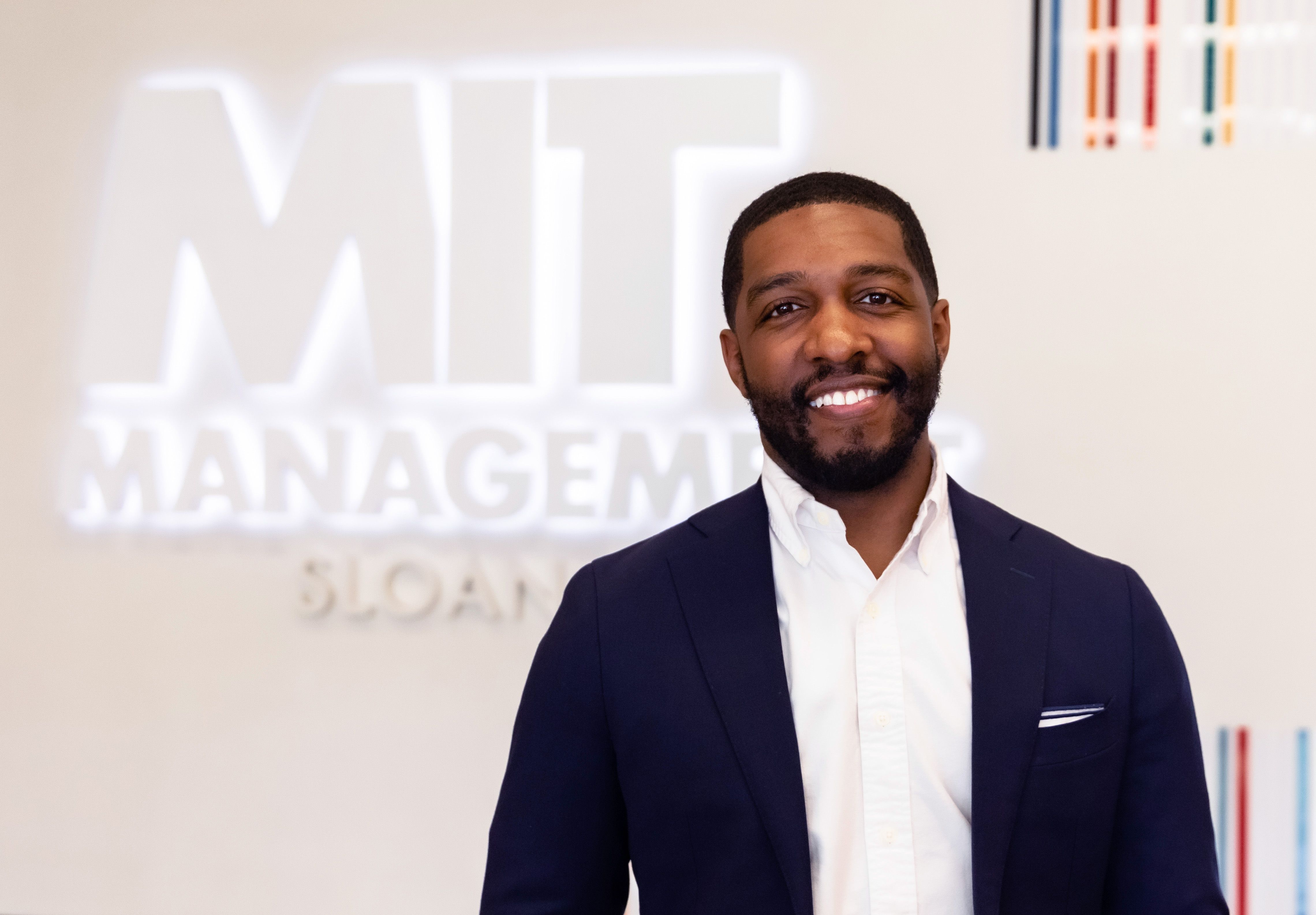 Kyle Gordon poses in MIT Sloan main building on campus