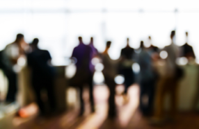 Blurry photo of large group of people networking