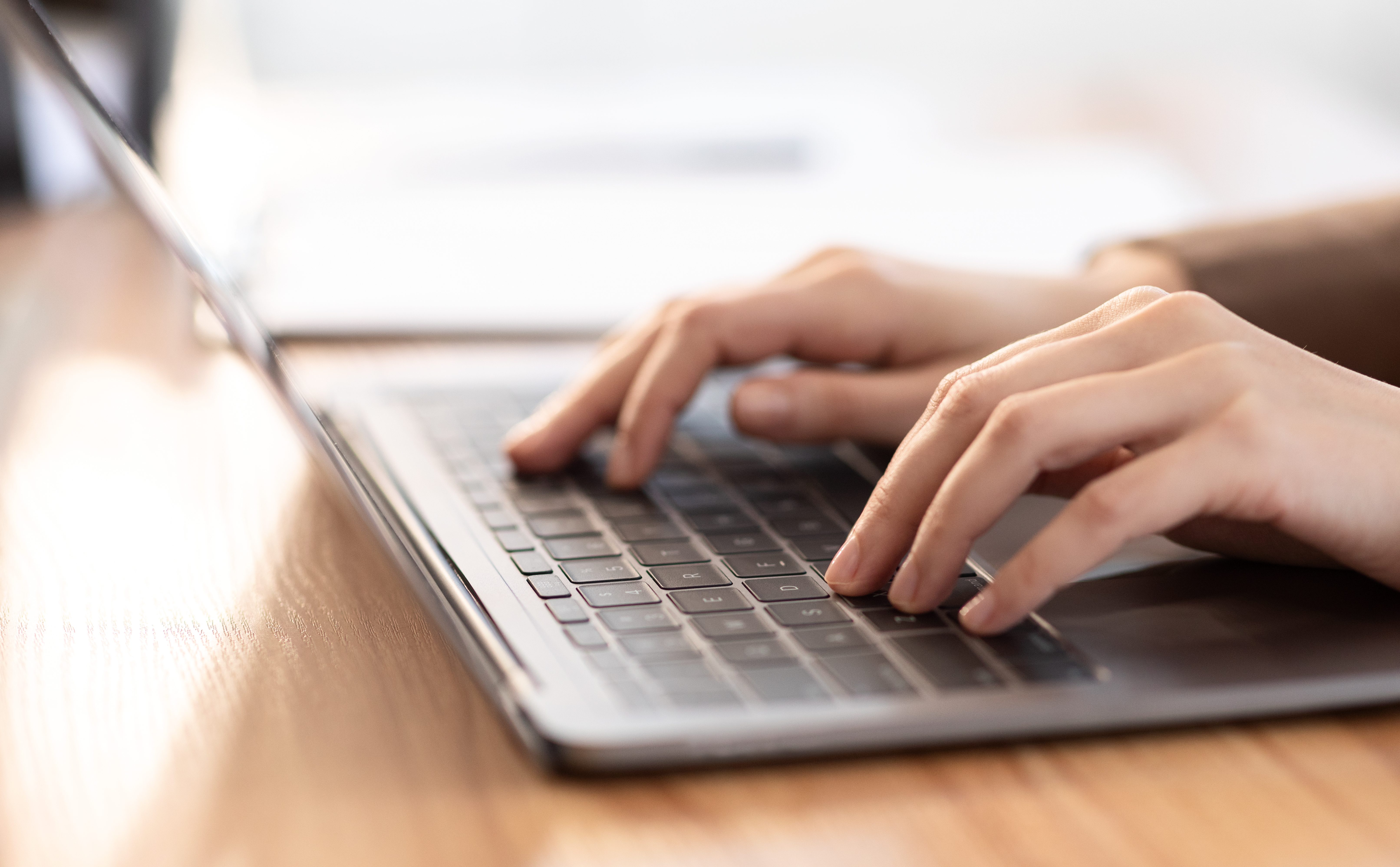 Person typing on laptop.