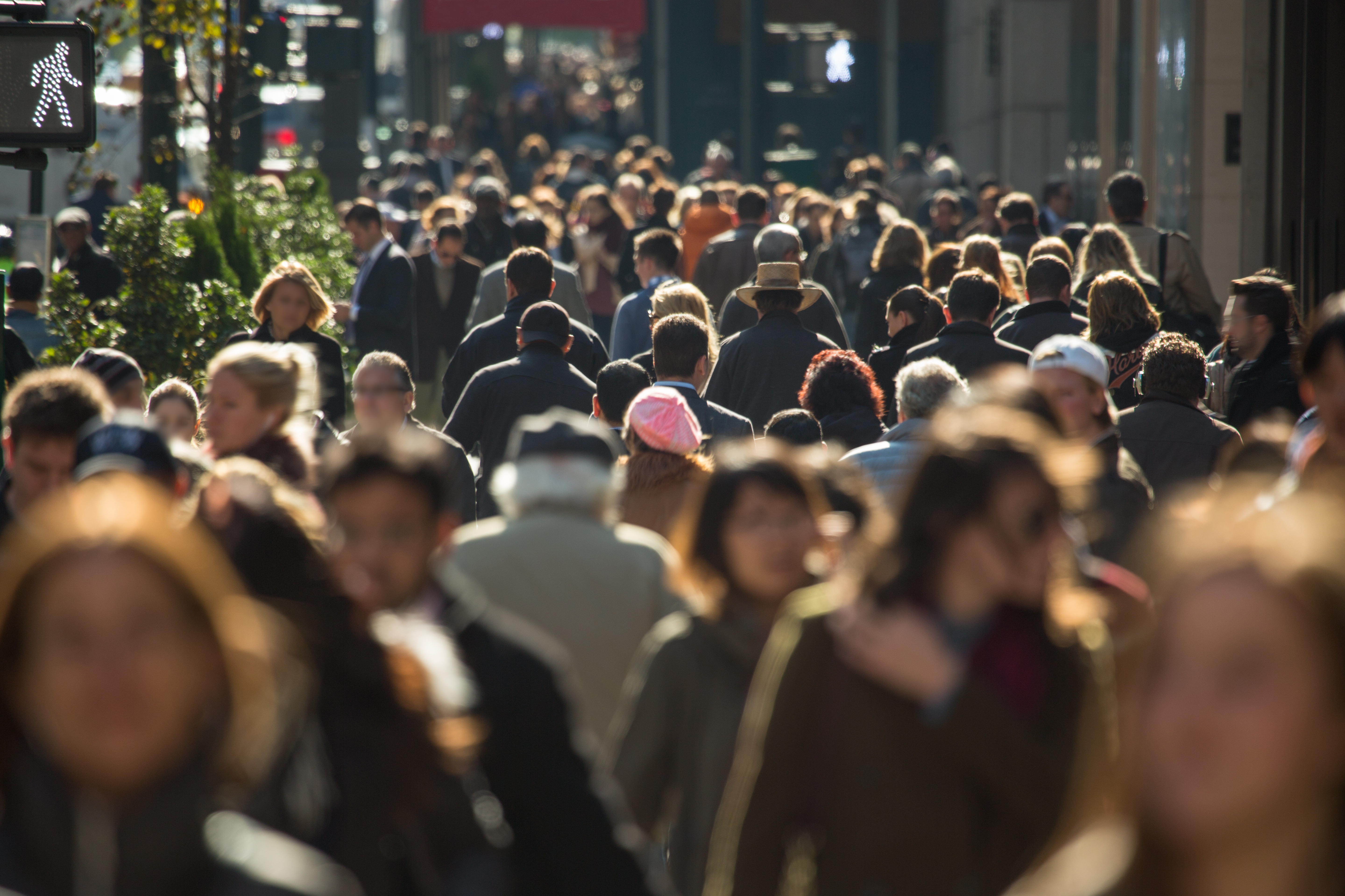 Blurred crowd on busy street.
