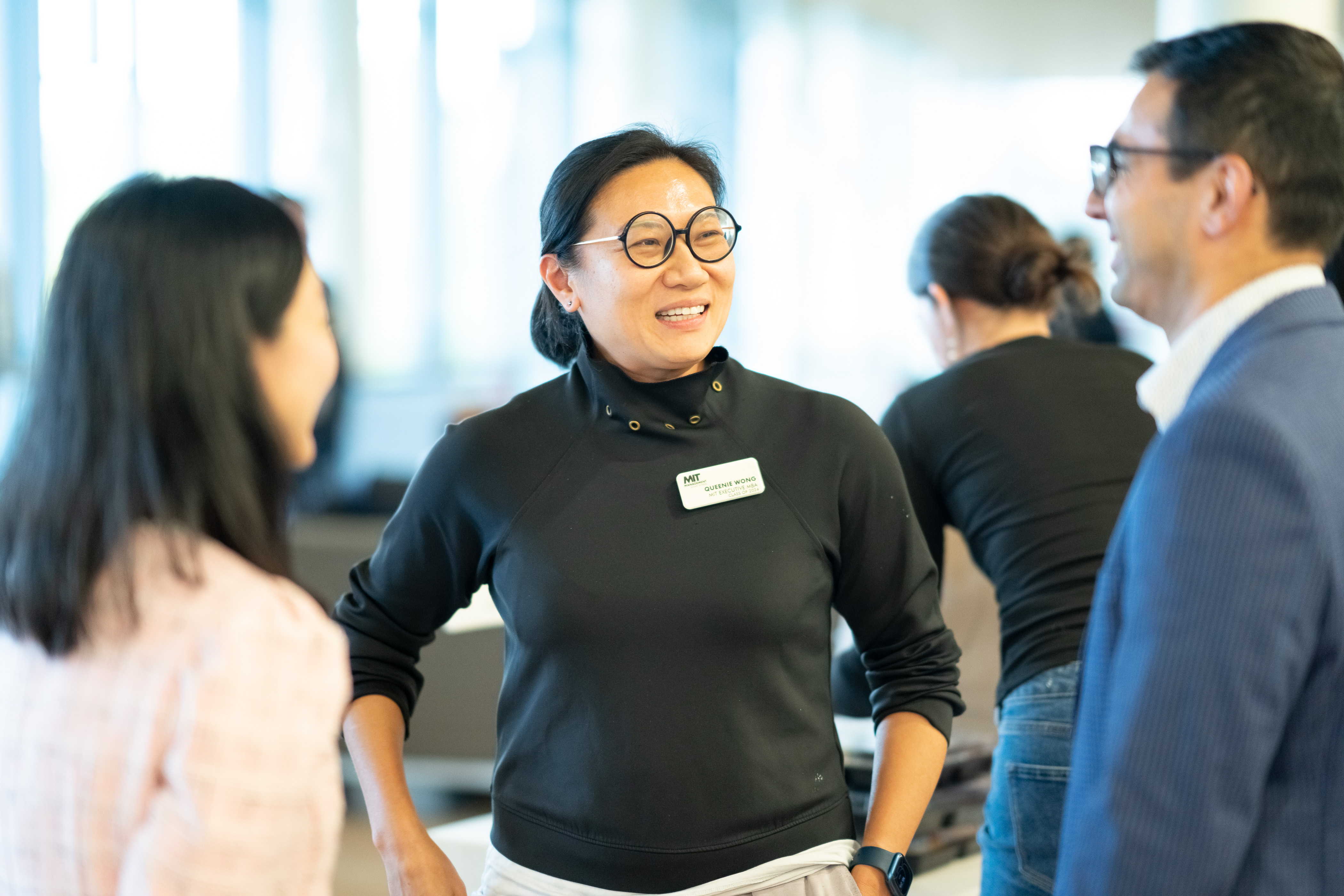 EMBA '24 students talking in the hallway