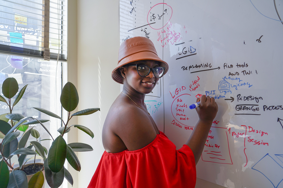 A woman writes on a whiteboard